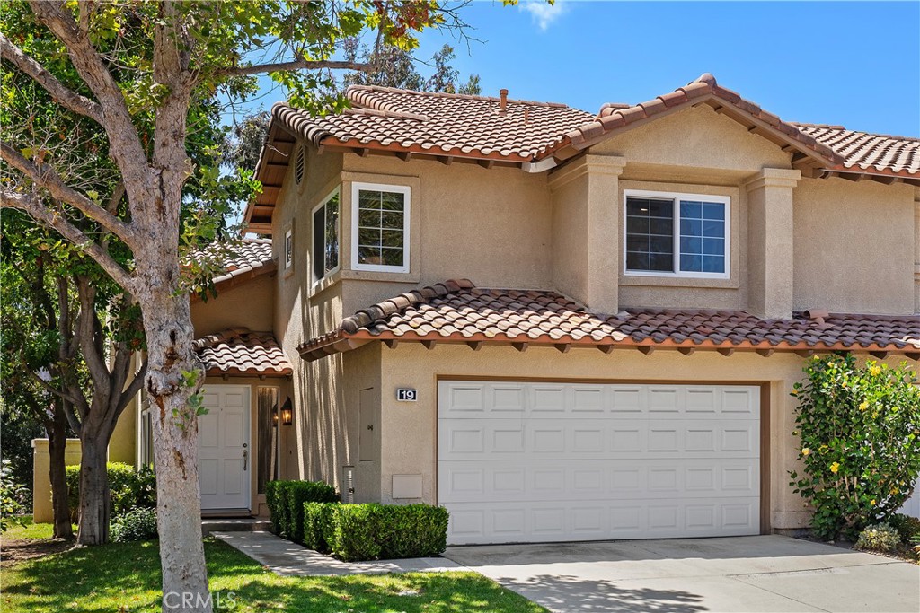 HIGHLY UPGRADED END-UNIT TOWNHOME WITH VIEWS AND THE MOST POPULAR FLOOR PLAN IN THE SOUGHT-AFTER TIERRA LINDA COMMUNITY. The largest model in the community, this beautifully upgraded 3-bedroom, 2.5-bath end-unit townhome features an open, light-filled layout with high ceilings, travertine-style tile flooring downstairs, and luxury vinyl plank flooring upstairs. Newer dual-pane windows provide energy efficiency and year-round comfort. The inviting family room includes a custom fireplace and sliding glass doors that open to a spacious private patio—ideal for relaxing or entertaining. The stunning kitchen showcases white cabinetry, granite countertops, a designer glass-and-tile backsplash, drop lighting above the large peninsula, and stainless-steel appliances. Upstairs, a stylish wood staircase leads to an airy landing, the expansive primary suite, two additional bedrooms, and a second remodeled bathroom. The primary suite features vaulted ceilings and tranquil treetop views. Its remodeled ensuite bath offers a floor-to-ceiling tiled shower, dual-sink vanity, and a walk-in closet with built-in shelving and a shoe rack. Additional highlights include an attached two-car garage with direct access, epoxy flooring, built-in storage, and a full driveway. The home has been re-piped with PEX, and the HOA is currently completing a new roof and fresh exterior paint across the community—the $25,000 special assessment will be paid by the seller at closing. Enjoy resort-style amenities including a pool, spa, BBQ area, and full SAMLARC privileges. Ideally located near Tijeras Creek Golf Course, award-winning schools, scenic parks, hiking and biking trails, dining, shopping, and major commuting routes.
