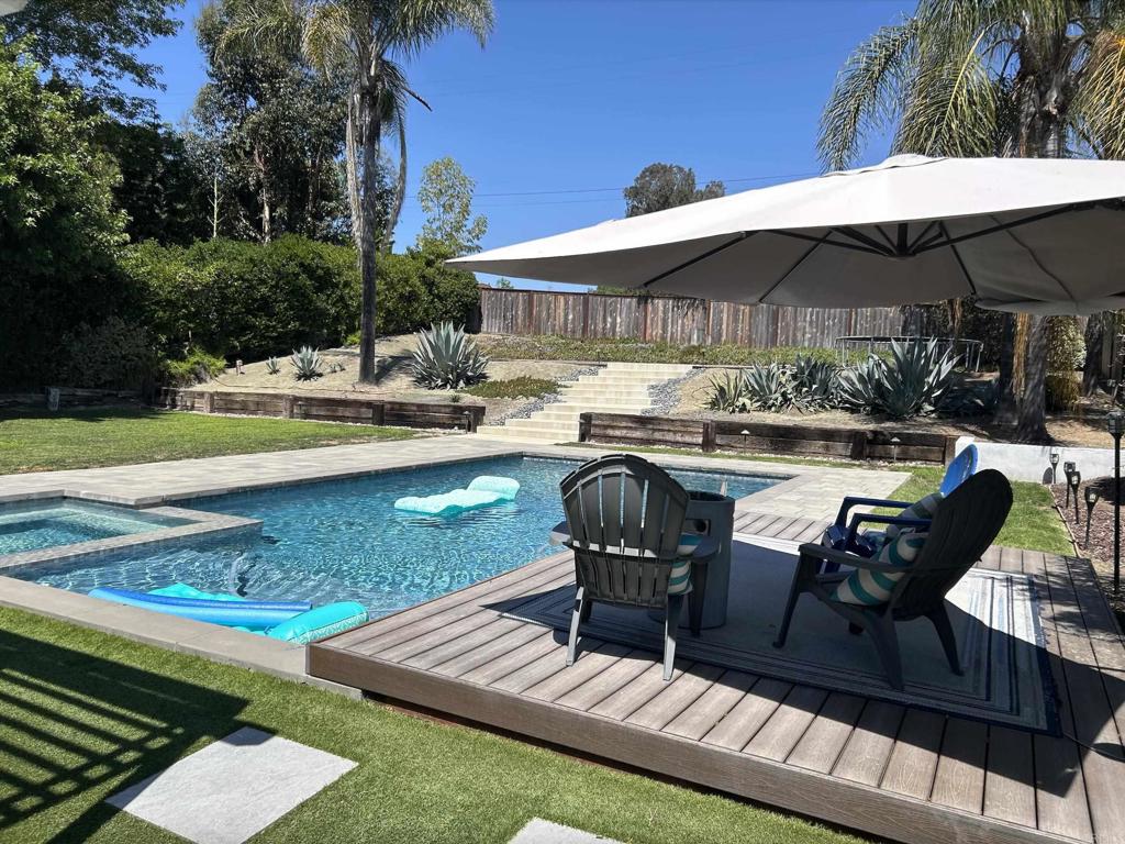 Luxurious Equestrian Retreat with Saltwater Pool, Spa, and Solar. Saddle up for this stunning 2,883 sq. ft. home lot over 1/3-acre in the coveted Carriage Hills equestrian community of Vista (zoned for horses), south of the 78 Fwy. Nestled on a charming cul-de-sac, this rare gem offers 4 bedrooms and 3 full bathrooms (1bed/1bath downstairs), 3-car garage and large driveway fit for multiple vehicles. Step inside to soaring vaulted ceilings in the formal dining and living room, warmed by one of two fireplaces. Rich dark wood floors guide you to the family room, showcasing a backyard with a picturesque view of the Pool oasis. The kitchen features white shaker cabinets, caramel travertine counters, and stainless steel appliances. Upstairs, the expansive primary suite impresses with vaulted ceilings, large sitting area, and covered outdoor deck. The ensuite bathroom boasts dual sinks, pedestal bathtub, tiled shower, walk-in closet and secondary closet. The other two upper bedrooms are flanked by a third bath with dual sinks. Outside, unwind in the custom saltwater Pool and Spa, surrounded by a sprawling flat yard ideal for entertaining. Relax under the pergola, bask by mature trees offering serene privacy, or follow the back path to a perfect spot for a casita, ADU, or volleyball court. This tranquil sanctuary feels like an escape from the city while just minutes from freeways, shops, restaurants, public transit, and the vibrant cities of Carlsbad, Oceanside, San Marcos or a short 15 minute drive to the beach. Carriage Hills offers a unique equestrian lifestyle with a community horse arena, riding/walking trails, a playground, dog park, and picnic areas - all for a low HOA fee. Vista’s ideal Mediterranean climate (averages 67–83°F) for year-round comfort. Explore this equestrian paradise today!