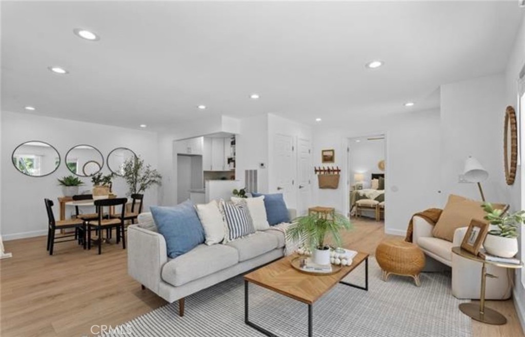 Welcome to this completely remodeled single-level stunner in the heart of Aliso Meadows, Laguna Hills. This exceptional 3 bedroom, 2 bathroom attached home boasts the largest and most beautifully updated floor plan in the community, offering a rare blend of luxury, comfort, and convenience. Rebuilt from the studs up, nearly every element is brand new, making this residence a true standout. As you step inside, natural light floods the open-concept living space, highlighting the elegant white oak luxury vinyl flooring and freshly finished walls. The expansive family room features a large sliding glass door that opens to a private patio, while a versatile nook provides the perfect space for a home office, reading area, or play zone. The adjacent dining area flows seamlessly into a chef’s dream kitchen, complete with brand-new white shaker cabinetry, quartzite countertops, a deep modern sink, and sleek stainless steel appliances. Every finish has been thoughtfully selected for both style and functionality. The private primary suite is a serene retreat, offering direct access to the patio, dual mirrored closets, a modern ceiling fan, and a spa-inspired ensuite bathroom. The ensuite features a white vanity topped with marbled quartzite, brushed steel fixtures, a frameless glass shower, and a separate toilet area. Two additional bedrooms are equally well-appointed with mirrored closets and ceiling fans, and they share a beautifully remodeled bathroom with designer touches including quartzite counters, shaker cabinetry, and frameless glass doors. Additional highlights include in-unit laundry, ample storage, and a spacious vinyl-fenced patio with mature fruit trees—ideal for morning coffee, weekend BBQs, or relaxing evenings with friends and family. Beyond aesthetics, this home has been upgraded with new HVAC ducting, air conditioning, furnace, water heater, PEX piping, electrical panel, and subfloor, ensuring peace of mind and energy efficiency. Located in a quiet, well-maintained community just steps from the Aliso Creek Trail, parks, top rated schools, shopping, dining, and minutes from world-class beaches and major freeways, this home offers the perfect balance of tranquility and accessibility. This is more than a remodel, it’s a complete transformation. Homes like this are rare, and this one is ready to impress.