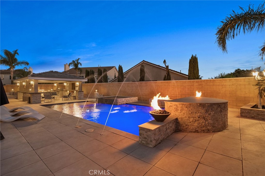 Welcome to 12391 Dakota River Drive—an exceptional Eastvale residence where luxury living meets resort-style comfort. This beautifully maintained home offers the perfect blend of style, functionality, and incredible outdoor living—ideal for those who love to entertain or simply unwind in a private retreat. The resort-style backyard is a true showstopper, featuring a sparkling pool and spa, custom-built BBQ island, and an expansive covered patio/pergola designed for year-round enjoyment. The outdoor space is enhanced with multiple fire features, including fire bowls around the pool, a cozy fireplace under the pergola, and a built-in fire pit—creating an inviting ambiance day or night. Even better, the permitted pergola is approved for enclosure as an ADU, offering incredible flexibility for future guest quarters, rental income, or multigenerational living. Inside, you’ll find a spacious and well-designed floor plan with multiple living and dining areas, a modern kitchen with quality finishes, and a large upstairs loft—perfect for a home office, media room, or additional living space. The home also features a convenient downstairs bedroom and full bathroom, ideal for guests or multigenerational living. Upstairs, the generously sized bedrooms include a luxurious primary suite, offering a peaceful retreat filled with natural light. Throughout the home, you’ll find thoughtful design touches that combine comfort and style. Located in one of Eastvale’s most desirable neighborhoods, you’re just minutes from award-winning schools, beautiful parks, shopping centers, and major freeways—making everyday life both convenient and connected. Don’t miss this rare opportunity to own a true entertainer’s paradise with ADU potential in the heart of Eastvale.