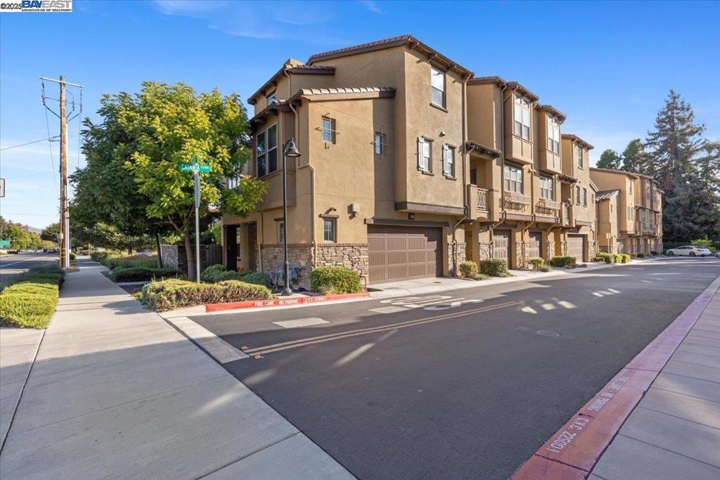 All are Welcome! This lovely townhome, built in 2018, features fresh interior paint, exquisite engineered hardwood floors, recessed lighting, and a central HVAC system. Ascend to the 2nd floor and be welcomed by a dramatic living room with soaring 2-story ceilings and an abundance of natural light. The open dining area flows seamlessly into a chef’s kitchen equipped with stainless steel appliances and a gas range, perfect for culinary creativity. The master bedroom boasts high ceilings and a spacious walk-in closet, while the master bathroom exudes elegance with dual sinks and a beautifully tiled shower with glass enclosure doors. The generous 2-car garage offers ample space for storage or a hobby area, complemented by a water softener and RO faucet for pure drinking water. Enjoy your private fenced backyard oasis. With an HOA of $344 monthly and convenient access to the Bart station and highways 680 and 880, commuting is effortless. This gorgeous, ready-to-move-in townhome is a true gem waiting for you. A few pictures are virtually staged. The living room and one bedroom are virtually staged.