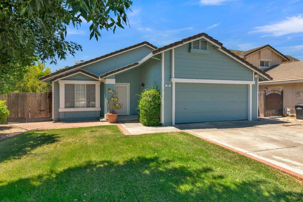 Tucked away in a quiet cul-de-sac, this charming single-story home offers 1,262 sq ft of comfortable living space on a 6,341 sq ft lot. The layout features three bedrooms and two full bathrooms, with a living room at the front of the home and a hallway connecting the bedrooms, bathrooms, and attached two-car garage. The open-concept family room, dining area, and kitchen with a breakfast bar create a bright, inviting space for gatherings. Sliding glass doors off the dining area lead to a covered back patio overlooking a lush backyard with well-established fruit trees, a table grape vine, and drip irrigation. A storage shed provides additional space for tools and hobbies. Conveniently located near schools, this move-in ready home combines comfort, functionality, and a great location.