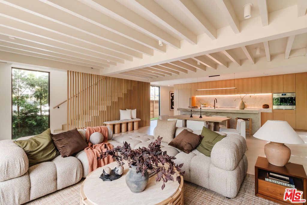 Nestled in Venice's charming walk streets, steps from lively Abbot Kinney and sunlit Pacific shores, this reimagined 2025 masterpiece spans over 3100 square feet, blending modern sophistication with warm organic elegance.Lush hedges embrace this serene sanctuary, featuring a 4-bedroom, 4-bathroom main house and a bright 1-bedroom, 1-bathroom guest unit perched above a spacious 2-car garage, seamlessly woven into nature.A majestic olive tree anchors a tranquil outdoor haven, perfect for relaxed gatherings and alfresco dining. Inside, the first floor opens with large-format tile radiating earthy luxury, where bronze anodized aluminum pocket sliders glide open to blend airy interiors with lush outdoor spaces, creating the quintessential Venice oasis. The chef's kitchen, crafted for culinary artistry, showcases white oak cabinetry, Taj Mahal quartzite countertops, luxurious appliances and Wolf stone cooktop and oven.Upstairs, white oak floors flow through three bedrooms, each exuding warmth, while the primary suite's Ocean Silver travertine shower evokes five-star hotel indulgence. This Venice gem, with its refined modernity and warm sophistication, redefines coastal elegance for intimate gatherings and grand celebrations.