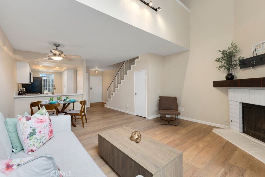 Welcome to this beautifully updated 1-bedroom, 1.5-bath, 2-story townhouse that blends modern comfort with classic style. The living room showcases soaring ceilings and an oversized window that fills the space with natural light. An open layout flows seamlessly to a private patio—perfect for entertaining or enjoying a quiet evening outdoors.

The remodeled kitchen features sleek finishes and generous cabinetry, while the upgraded half bath on the main floor offers added convenience. Upstairs, the spacious bedroom suite provides privacy, comfort, and a full bath, creating the perfect retreat.

Additional highlights include elegant laminate wood flooring throughout, in-unit laundry, and a detached 1-car garage with secure parking and storage. With tasteful upgrades and a welcoming design, this townhouse is move-in ready and waiting for its next owner.