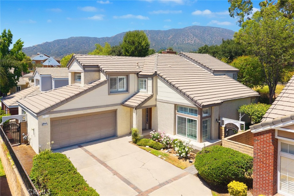 Nestled in one of North La Verne’s most coveted gated enclaves, this beautifully upgraded 4-bedroom, 3-bathroom home offers the perfect blend of space, comfort, and tranquility. Situated at the end of a quiet cul-de-sac with a long private driveway, this home enjoys ultimate privacy while being just minutes from top-rated Bonita Unified schools, parks, hiking trails, shopping, dining, and freeway access.
Step inside to soaring ceilings, newly installed hard flooring throughout, and an inviting formal living and dining area. The gourmet kitchen features granite countertops and seamlessly opens to the cozy family room with fireplace—an entertainer’s dream. A light-filled, fully permitted sunroom sits just off the family room, surrounded by lush greenery and perfect for year-round enjoyment.
The flexible floor plan includes a downstairs bedroom and full bathroom—perfect for guests or multigenerational living. Upstairs, the luxurious primary suite features French doors to a private balcony with retractable awning, a spa-like bathroom, and a large walk-in closet. Two additional bedrooms are bright and spacious, with ceiling fans in each room.
The backyard is truly a retreat, with cobblestone walkways, lush landscaping, and shaded sitting areas that create a peaceful garden sanctuary.
Don’t miss this rare opportunity to own a turn-key home in one of La Verne’s most peaceful and private neighborhoods.
