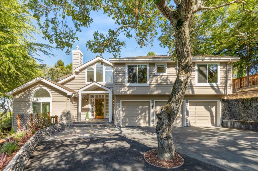 Tucked just around the corner from Emerald Lake Country Club & surrounded by grand oak trees, 100 Vaquero is a thoughtfully updated & maintained contemporary retreat, offering 3484 sq ft of sophisticated living on a generous .6-acre corner lot. The home is airy & inviting, defined by soaring ceilings, natural light & flowing proportions. The kitchen anchors the home with expansive work surfaces & sunlit eat-in area, seamlessly complemented by a butlers pantry with pull out organizers. A separate family room adds warmth to the open layout, while a formal dining room is perfect for gatherings. The primary suite is its own sanctuary: private sitting room, cozy fireplace, spa-like bathroom & walk-in closet. With 3 of the 4 bedrooms offering en-suites, the home accommodates with both elegance & ease. Outdoors, the property celebrates its setting. A treehouse & chicken coop bring whimsy, while planter beds, fruit trees & outdoor kitchen move seamlessly from garden to table. A broad deck frames stunning hillside & bay views. Additional features include 3-car garage with EV charger, AC & meticulous updates throughout. Top rated Roy Cloud School. All just steps from the lake, 100 Vaquero Way is more than a home-its a way of life, where modern design meets the ease of California living.