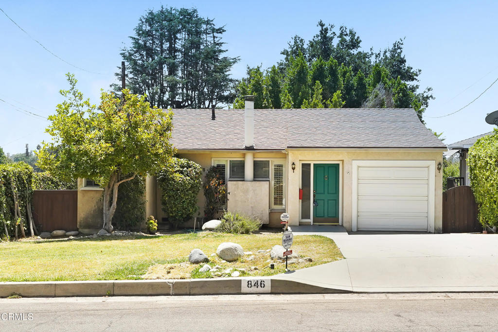 Tucked into the peaceful foothills of Monrovia, this charming 2-bedroom, 2-bathroom home blends classic comfort with outdoor serenity. Step inside to find a spacious living room featuring hardwood floors, crown molding, and a beautiful fireplace flanked by tall windows that fill the space with natural light. The adjacent kitchen is bright and functional, offering granite countertops, ample cabinetry, and direct access to the backyard. Both bedrooms are generously sized, with the primary suite offering mirrored closets and an ensuite bath with a walk-in shower. A bonus room, converted from the garage, provides a perfect space for a home office, studio, or additional storage. Outside, the covered deck offers a quiet retreat for morning coffee or evening gatherings, overlooking a large, private yard dotted with fruit trees and mature landscaping. With a deep driveway, attached garage, and close proximity to nature trails and Old Town Monrovia, this home is a rare opportunity to enjoy foothill living at its finest.