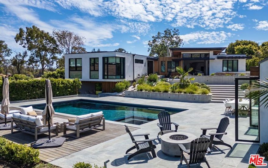 At the end of a quiet cul-de-sac in coveted Point Dume, this private estate unfolds across nearly an acre of landscaped grounds with tree-top vistas and distant mountain views. Designed with a blend of warmth and contemporary elegance, the property offers a total of 7 bedrooms and 6 baths between the main residence and guest house. The main home spans approximately 6,500 square feet with airy, light-filled living spaces, wide-plank wood floors, and skylights that highlight its contemporary modern yet inviting character. An open great room connects seamlessly to the chef's kitchen, where Thermador appliances, a large island, and folding accordion windows make entertaining a natural extension of everyday living. A versatile lower level provides space for a media lounge, gym, or game room. Tucked on its own private section of the lot, the newly built approx. 850-square-foot guest house offers two bedrooms, a full bath, and a complete kitchen with high-end finishes  perfect as a private retreat or accommodations for visitors, outdoors, the estate is designed for leisure and gatherings alike, with a sparkling pool and spa, patios with built-in firepits, BBQ area, and rolling grassy lawns. The result is a serene sanctuary that captures the essence of Malibu living, Ideally positioned near Point Dume State Beach, scenic trails, and Malibu's vibrant dining and shopping, 29201 Larkspur Lane offers the perfect balance of sophistication, comfort, and coastal charm.  Flexible lease terms available short-term, seasonal, or monthly rentals considered. Ideal for those seeking a Malibu getaway or transitional housing. Rates subject to length of stay and season. Discounted Rental rate because of neighboring construction.