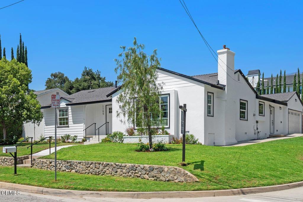 Completely reimagined and thoughtfully expanded, this beautifully remodeled 4 bedroom, 4 bath corner-lot home in the heart of La Canada Flintridge offers the perfect blend of modern amenities and everyday comfort. The grassy front yard features a welcoming pathway and stairs that lead to a charming covered porch. Inside, the open floor plan seamlessly connects the living room, with its cozy fireplace and large paned picture window, to the stunning chef's kitchen featuring brand-new appliances and an oversized island. The kitchen flows into a spacious family room with a convenient half bath and access to the attached garage and backyard, creating a true hub for gathering and entertaining. The generous primary suite features a large closet, a full ensuite bath, and direct access to the backyard. Two additional bedrooms share a full bath, while the fourth bedroom has its own private 3/4 bath and separate backyard access. A centrally located laundry room adds everyday convenience. Outside, the private backyard oasis with a sparkling pool and a large patio are perfect for lounging, dining, or entertaining. Located near the award-winning La Canada Elementary School, Memorial Park, and just minutes from shopping, dining, and other local amenities, this single-level home delivers style, flexibility, and an unbeatable location in one of the area's most desirable neighborhoods.