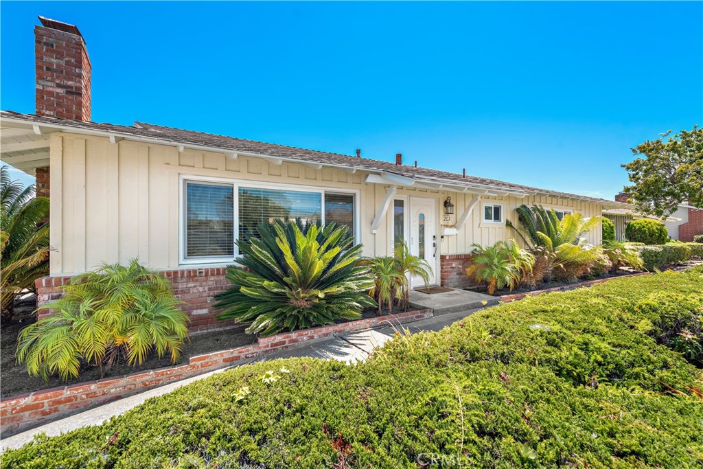 Live the refined, beach-close lifestyle you’ve imagined at this impeccably reimagined single-level ranch home in San Clemente. Nestled within Bay Cliff Village—a coveted 55+ enclave of just 28 residences—this two-bedroom, two-bath retreat lives like a detached home, sharing only one wall. A curated blend of timeless character and modern elegance defines the property, where used brick, board-and-batten siding, and meticulous landscaping echo its 1962 heritage, while every interior detail reflects an inspired, contemporary sensibility.
The approximately 1,266-square-foot floor plan unfolds with effortless flow, introduced by a custom front door that opens to a sunlit living room anchored by a bespoke fireplace. The dining area extends seamlessly to a private patio through Milgard sliding doors, while the chef’s kitchen delights with Shaker cabinetry, quartz counters, a full tile backsplash, a pantry, French-door refrigerator, and a suite of Bosch stainless-steel appliances including a five-burner cooktop, oven, microwave, and dishwasher. The guest bath features a quartz countertop and frameless glass shower enclosure, while the primary suite offers a generous closet and an ensuite bath with granite countertops, a walk-in shower, and slate tile surrounds.
Thoughtful upgrades abound, including a whole-home water filtration system, tankless water heater, newly installed Hunter Douglas window coverings, and energy-efficient Milgard windows. Floors of woodgrain porcelain tile complement custom paint, Shaker-style interior doors, recessed lighting, and a laundry closet with full-size washer and dryer. Outdoor living shines with a Trex deck and irrigated landscaping, complemented by direct, private access from the patio to a separate one-car garage—one of only four in the community with this rare advantage. The garage includes built-in storage, and both the home and garage were re-roofed in 2024. A recently sleeved sewer line adds peace of mind, ensuring the property is as functional as it is beautifully maintained. Home can be purchased fully furnished at an additional cost.
Bay Cliff Village is designed for connection, with meandering pathways, lush central park spaces, and a welcoming clubhouse for neighborhood gatherings. Moments from the sand, Shorecliffs Golf Club, San Gorgonio Park, and local shopping, this home blends everyday ease with coastal sophistication.