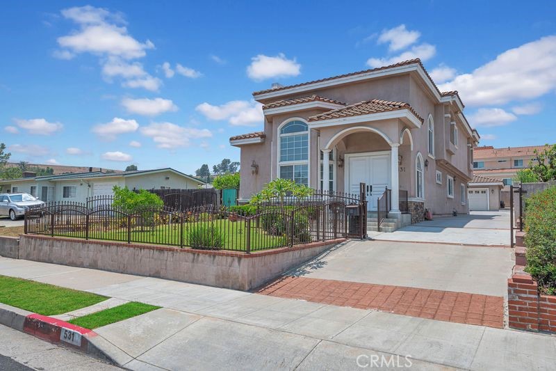 Welcome to this gorgeous single-family residence, perfectly situated in a sought-after Monterey Park neighborhood. Behind a gated entrance, double entry doors open into a grand foyer leading to a high-ceilinged living room with a cozy fireplace. This home features two spacious master bedrooms, perfect for multi-generational living. Main floor, One master bedroom suite with its own full bathroom, office can easily be converted to a 5th bedroom, with the second full bathroom conveniently located nearby. Open-concept kitchen boasting granite countertops, ample cabinets and drawers. Combined family room and dining area ideal for seamless entertaining. Upstairs, the loft is ideal for children's play area or a homework station. Spacious second master suite with dual-sink vanity, soaking jacuzzi, and separate shower. Two additional bedrooms sharing a full hallway bathroom. Hardwood flooring, tile and recessed lighting throughout the home offer a modern and cohesive look. this home equipped with two A/C units and two water heaters, ensuring year-round comfort and efficiency. Detached 3-car garage located in the backyard, proving ample parking and storage space. Just minutes from Garvey Ranch Park, markets, restaurants, and schools. A must-see property you don't want to miss!