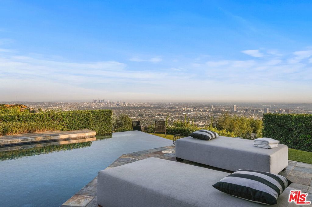 Nestled on a small cul-de-sac off Blue Jay Way in the exclusive Bird Streets, this single-story jewel-box boasts unobstructed 180-degree jetliner views from Downtown LA to the Ocean. With an open floor plan, the living area offers ceilings and stunning herringbone-patterned wood floors. The recently remodeled chef's kitchen opens to the striking view with a massive center island with gorgeous marble waterfall countertops and built-in seating for 6. An impressive owner's suite opens out to the sleek infinity-edge pool, stone-tiled deck, and grassy yard with an outdoor kitchen/BBQ. 2-car garage with additional private driveway spaces.