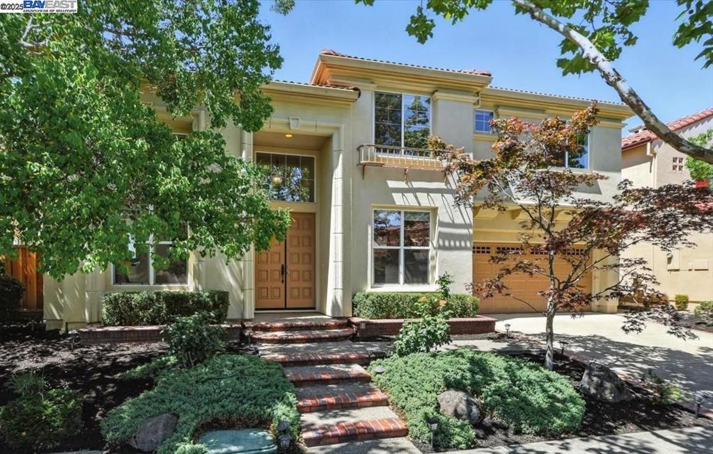 Stunning East facing home in San Ramon’s sought-after Bridges community, surrounded by rolling hills, tree-lined views, and golf courses, offering a peaceful and scenic setting. Tucked away on a quiet street, boasts exceptional curb appeal and a versatile floor plan with a bedroom, full bath and an office on the main level. Soaring vaulted ceilings, fresh interior paint, and brand-new carpet enhance the bright and open feel. A dramatic high bay window in the living room frames the beautiful tree-lined views, filling the space with natural light. The open kitchen showcases double ovens, two sinks, a full backsplash, and a cooktop with center griddle—ideal for everyday living and entertaining. A flexible office with wine cooler can easily convert to a sixth bedroom. All bedrooms are generously sized, including the luxurious primary suite with stately double-door entry and his-and-her closets, each with mirrored doors. Additional highlights include a whole-house central vacuum system, water service from East Bay Municipal Utility District, and an expansive backyard offering space to relax, play, and garden. Perfectly located near Coyote Creek Elementary, neighborhood trails, top-rated San Ramon schools, shopping, and freeway access.