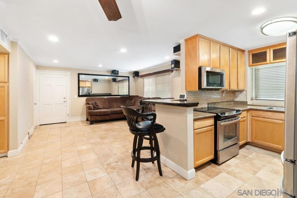 ASSUMABLE VA LOAN | LUXURY FINISHES | MOTIVATED SELLER Welcome to Village Walk, Lemon Grove’s premier gated community offering resort-style living. This completely remodeled 2-bedroom, 2-bathroom condo delivers exceptional upgrades and refined finishes throughout its 1,022 sq ft of living space. Interior Highlights: Elegant flooring: Beautiful tile flows seamlessly throughout the home, combining durability with timeless style. Distinctive finishes: Crown molding, recessed lighting, and designer paint create an inviting, polished ambiance. Upgraded kitchen & bar: Custom cabinetry, modern appliances, and abundant granite counters provide both beauty and function. Spa-inspired baths: Each bathroom is fully remodeled with full-wall porcelain tile, floating vanities, recessed lighting, and modern electric toilets for a spa-like feel. Comfort and efficiency: Central air conditioning with advanced air filtration ensures year-round comfort and clean air. Smart amenities: Double-pane windows with custom blackout shades, home-theater wiring, and energy efficient appliances make daily living effortless. Outdoor Retreat & Storage: A private lanai (patio) with custom storage closet offers a tranquil setting for morning coffee or evening relaxation. Community Perks: Residents enjoy a sparkling pool and spa, a fully equipped fitness center, clubhouse, playground, picnic areas, dog park, and barbecue zones. The gated community includes exterior building maintenance, water, and hot water in the HOA for worry-free living.