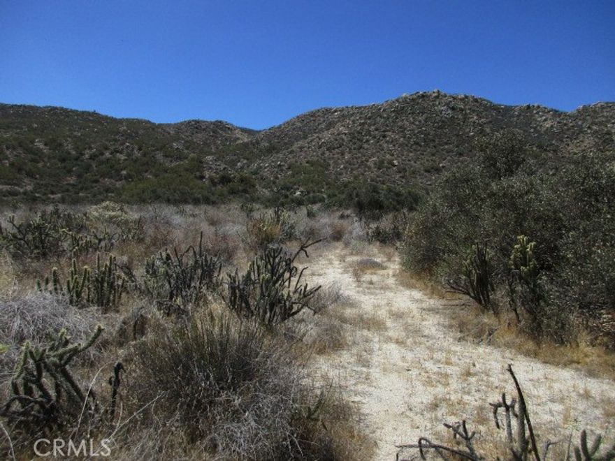 This 20 acre parcel in the Happy Valley area of Aguanga is almost all usable, with an elevated pad for sweeping views of the valley. Corners are marked. The area features 15-20 acre parcels with some very nice ranches. Electric lines are at the street. Well has not been drilled yet, but a well on the neighboring property is producing about 30 gallons per minute. Seller may finance!