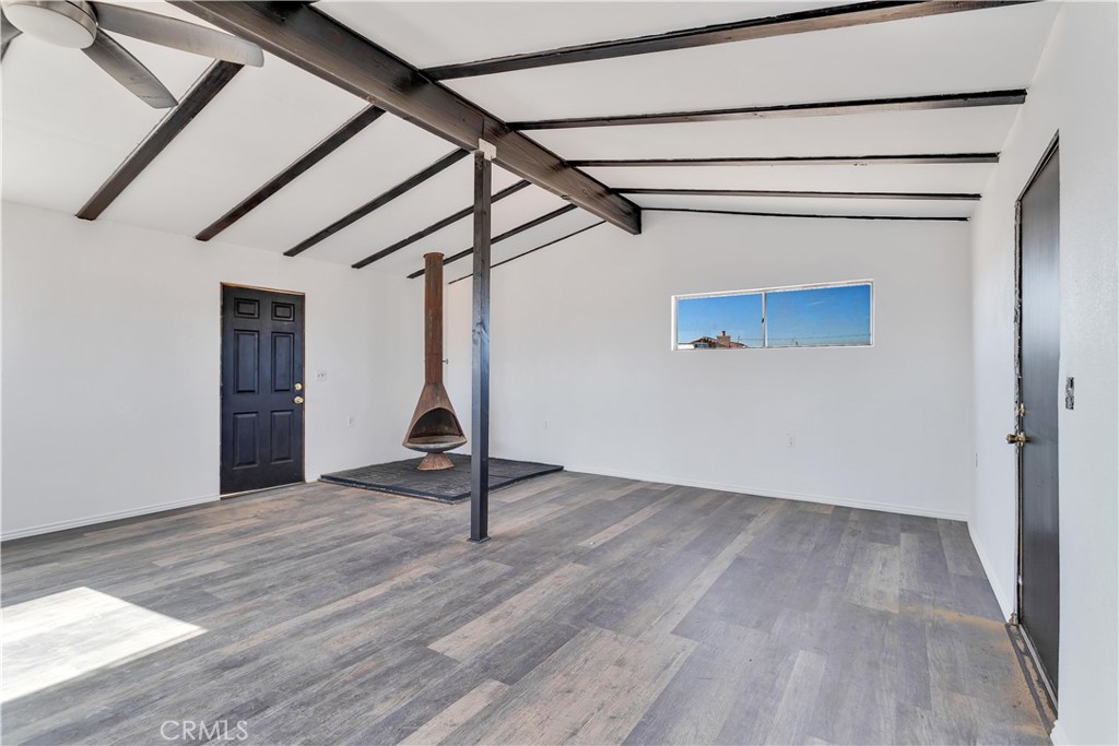 Joshua Tree back entrance location - Ultimate Wonder Valley private Rec Cabin with simple luxury in the High Desert on five expansive acres. Professionally renovated - this spectacular tiny home features an airy living and dining space with beamed ceiling with custom framed doors and windows, Morso WB fireplace and a generous living area. Brand new double lined stucco on the outside and fully insulated detailed craftsman finished work on the inside. NEW ROOF just installed and 20 foot beamed ceiling at the peak. Upgraded Electric Panel. The Power is on to this house and previously had hauled water. Bathroom and Kitchen framed will need to be finalized. Area is booming with Artists, New Restaurants, and Hip People of all ages.
Wonder Valley is less than 15 minutes from the entrance to Joshua Tree National Park! As you approach the property, 360 degree panoramic views surround you, stretching from JTNP to the south to Mojave Trails National Monument to the North. The charming facade with its stonework accents welcomes you to explore further w- 5 private acres, you have plenty of room to expand your dreams. There are fewer and fewer of these unique Rec Cabins that haven’t be bought up by big land companies - don't miss out on your chance to own your personalized hi-desert hideaway. Move in ready. Pictures say it all. Offered $79,900 Firm CASH.