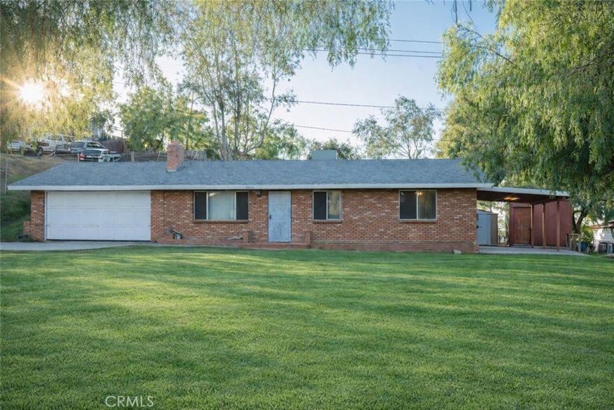 Welcome to this single-story home offering space, comfort, and versatility. Situated on a generous lot, this property provides a balance of functional living areas and outdoor potential.
Inside, the home features neutral paint tones, a spacious living area with a classic brick fireplace, and a layout designed for everyday living. The kitchen offers ample cabinetry, tiled flooring, and an adjacent dining area with direct access to the backyard—ideal for indoor-outdoor flow.
The bedrooms are well-sized with closet space, and the bathrooms feature tile finishes and updated fixtures. Additional highlights include ceiling fans, recessed lighting in select areas, and natural light throughout.
Outside, the expansive lot offers a variety of possibilities—whether you’re envisioning space for recreation, storage, gardening, or future improvements. Covered patio areas, storage sheds, and a long driveway add convenience and flexibility.
Enjoy a setting that offers room to breathe while still being conveniently located near local amenities, schools, and commuter routes.
A great opportunity for buyers seeking space, potential, and single-story living.