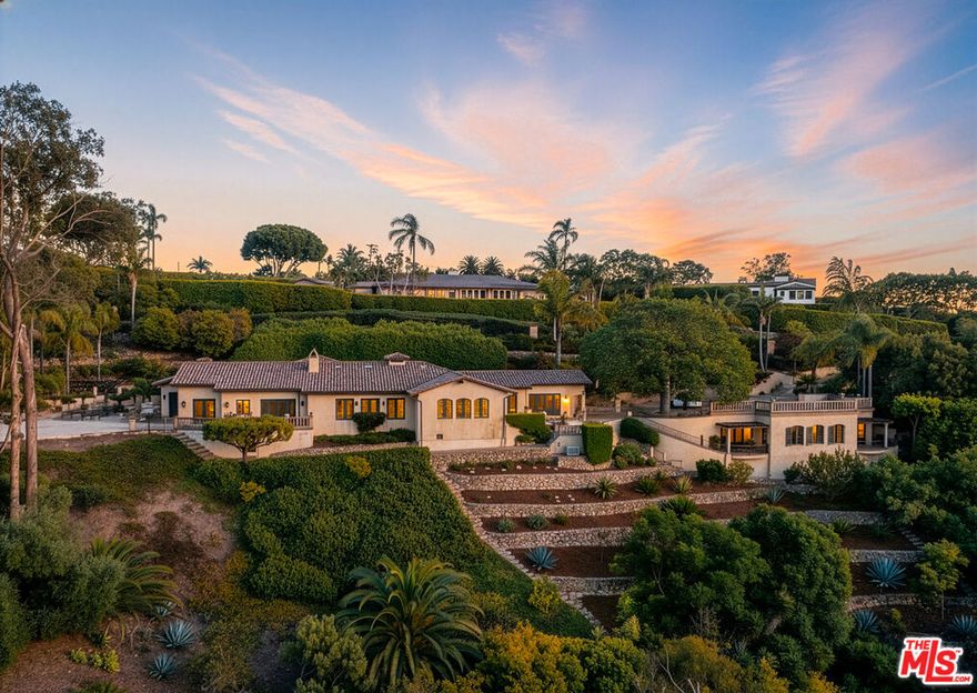 Overlooking one of the most dramatic vistas in Hope Ranch, this private Mediterranean-style retreat commands extraordinary panoramic views spanning from the mountains to the ocean and beyond. Rarely does a vantage point so magnificently capture the grandeur of Santa Barbara's natural beauty, particularly from a single-level main residence. Showcasing remarkable quality and designed for a life both refined and relaxed, the +/- 1.48-acre property offers elegant accommodations for residents and guests alike: a nearly 4,200 sqft main residence with an attached 2-car garage, a gated entrance and spacious ocean-view motorcourt, a detached +/- 1,322 sqft guest house, a sparkling pool, two offices, and more!Inside, an ocean-view family room with soaring, open-beam ceilings, a gorgeous stone fireplace, and French doors to the outside provides an inviting central gathering point. Adjacent to the family room is a stunning gourmet kitchen appointed with top-tier appliances, refined finishes, a sunny breakfast area, and panoramic views. The formal living and dining areas feature large windows and French doors opening to sweeping terraces and patios.The primary bedroom offers a luxurious getaway with an enormous bathroom suite and walk-in closet. A dedicated office boasts inspirational views and access to the outside. Throughout the home, nearly every room frames an unforgettable vista -- whether ocean, mountain, or garden -- infusing the home with abundant light and natural beauty.Steps from the main home, a private guest house offers additional flexibility, complete with a kitchenette, living room, office, and bedroom perfect for extended stays or creative pursuits. In addition to the sparkling pool that overlook the coastline, the grounds feature an explosion of various plantings and fruit-bearing trees, all surrounded by beautifully designed terracing, privacy hedges, and hardscaping. Altogether, the property provides a tranquil setting for endless moments of gathering, entertaining, or simply relaxing.Set within Hope Ranch's coveted coastal enclave -- where residents enjoy equestrian trails, private beach access, proximity to La Cumbre Country Club & Golf Course, and a rare sense of space and seclusion -- this exceptional property combines sweeping natural beauty with refined Santa Barbara living at its finest.