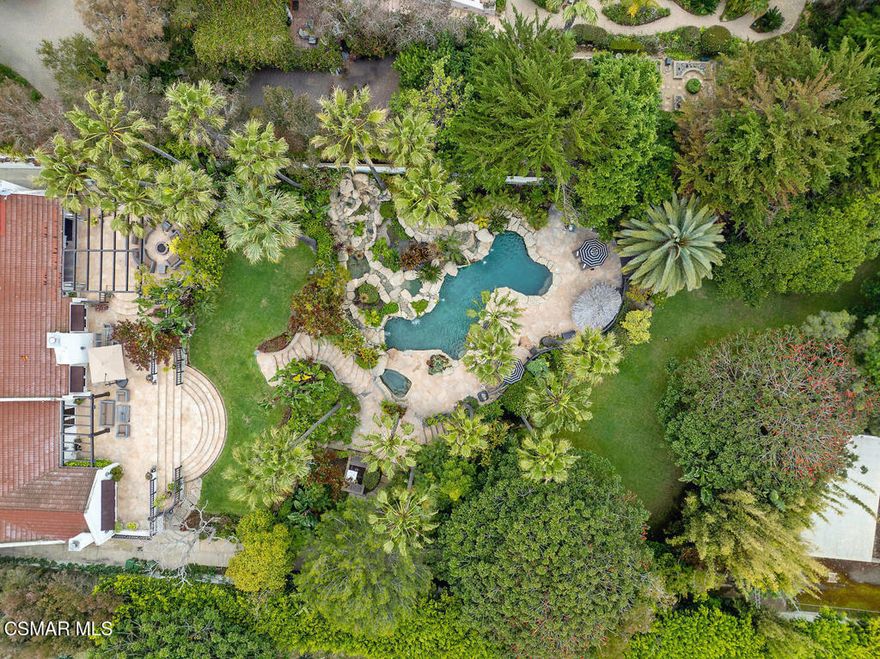 Welcome to this exquisite Malibu estate, a private retreat featuring 3 spacious bedrooms and 5 luxurious baths. Set behind a gated circular driveway and surrounded by over 40 majestic palm trees, the home offers an unparalleled sense of privacy and natural beauty.Inside, gorgeous hardwood floors flow throughout an open-concept layout. The gourmet kitchen is a chef's dream, complete with granite countertops, a central island with seating, and high-end appliances. The large family room, anchored by a cozy fireplace, seamlessly connects to the formal dining area--perfect for both casual and elegant gatherings.Custom folding doors open to an expansive patio, ideal for outdoor entertaining in a lush, serene setting. The home also includes a dedicated office and a separate library with built-in bookshelves, providing refined spaces for work or reading.The private primary suite is a true retreat, featuring French doors that lead to the patio, a generous walk-in closet, and a spa-inspired bathroom. Relax in the marble steam shower or enjoy the dual vanities designed for both luxury and function.A rare find in Malibu, this estate combines elegance, comfort, and exceptional outdoor living. Nestled in the heart of Malibu's coveted Point Dume enclave, this breathtaking single-story estate sits on 1.15 acres of impeccably landscaped grounds, offering the ultimate blend of luxury, privacy, and coastal charm.  Open-concept layout with vaulted ceilings, walls of glass, and seamless indoor-outdoor flow. Elegant finishes, serene, light-filled living spaces create a warm and sophisticated atmosphere throughout. Every room is designed to capture natural light and maximize the stunning views of the surrounding lush gardens.The property's exotic yard feels like a private tropical resort, with swaying palm trees, cascading waterfalls, and tranquil pathways winding through vibrant landscaping. A sparkling pool and spa take center stage, surrounded by inviting lounge areas and an outdoor kitchen perfect for entertaining under the stars. A detached guest house offers luxurious accommodations for visitors or a private office or studio, blending harmoniously into the verdant setting. Whether you're hosting gatherings or enjoying a quiet morning coffee by the pool, the backyard is a paradise of peace and beauty.Just a short walk away, the iconic Big Dume and Westward Beach invites you to experience the best of Malibu's coastline, from surf to sand, tide pools to trails. The home's location on the bluff ensures easy access to world-class natural beauty, while maintaining a sense of secluded serenity. Award winning Public Malibu Elementary school is one block away. California distinguished Public Malibu High school and Middle school have been beautifully renovated and are less than 3 miles away, with bus service. Shopping and restaurants are less than a mile away. This rare Point Dume offering combines timeless design with resort-style amenities in one of California's most desirable neighborhoods, making it a true Malibu gem.
