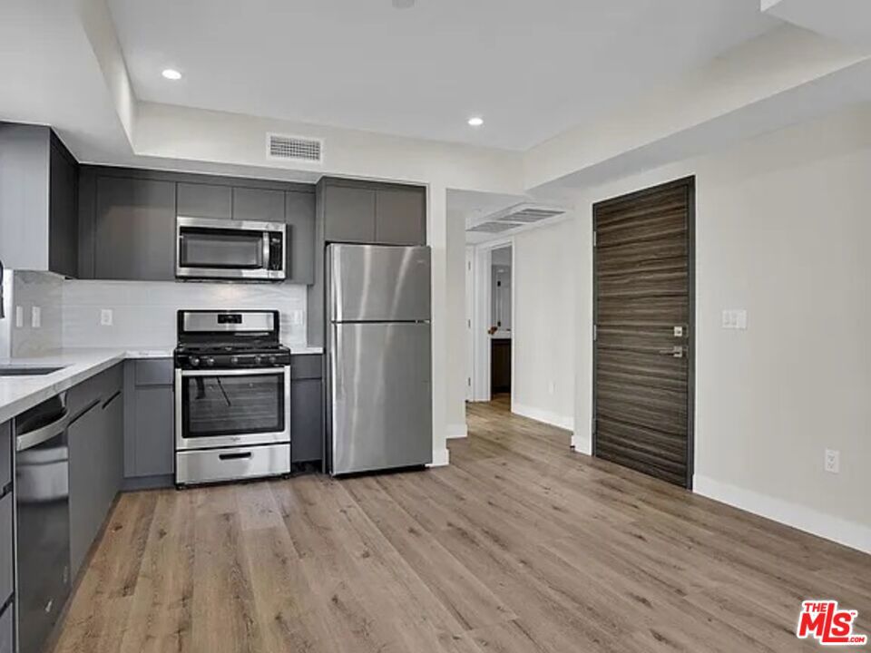 This building offers the perfect blend of luxury and convenience in the heart of prime Koreatown. Featuring high-end appliances and finishes throughout, this unit boasts a spacious, open-concept layout with sleek cabinetry, premium hardwood flooring, and stainless steel appliances. The thoughtful design and attention to detail make this home both stylish and comfortable. The building itself offers exceptional amenities, including a rooftop deck with a BBQ area ideal for entertaining while enjoying sweeping views of the city. Residents also benefit from secure gated garage parking, with an electric vehicle (EV) charger available upon request for those who embrace sustainable living. Centrally located, this apartment is just a short walk from a wide variety of shops, restaurants, cafes, and entertainment venues, giving you easy access to the vibrant energy of Koreatown. With its prime location, this home is just minutes away from Downtown LA, Hollywood, and other major city hotspots, providing unmatched convenience in one of LA's most sought-after neighborhoods.