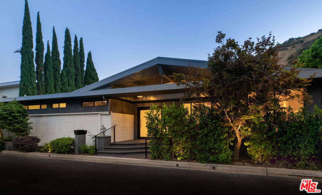 A rare mid-century retreat in Outpost Estates, offered through a limited-time auction, with all offers due September 15 at 5PM. Meticulously renovated with over $1M in upgrades, this 3,688 sq. ft. residence blends classic mid-century architecture with modern refinement. Recent valuation data support significant upside: comps indicate a $5M value, the property was previously appraised at $4.5M, and rental offers have reached $25K/month. The main home offers 4 bedrooms and 4.5 bathrooms, complemented by a detached guest suite for flexible living. Interior highlights include floor-to-ceiling glass, Italian marble, a La Cornue kitchen, and a hammered copper soaking tub. Multiple living areas open seamlessly to a pool, spa, and deck, creating a true indoor-outdoor lifestyle. Open houses scheduled: Sept 5 (11-2), Sept 6-7 (1-3), Sept 9 (11-2), Sept 12 (11-2), and Sept 13-14 (1-3). A unique opportunity to secure a fully renovated mid-century retreat in one of Los Angeles' most coveted neighborhoods available now, but not for long. See documents for Offer Guidelines