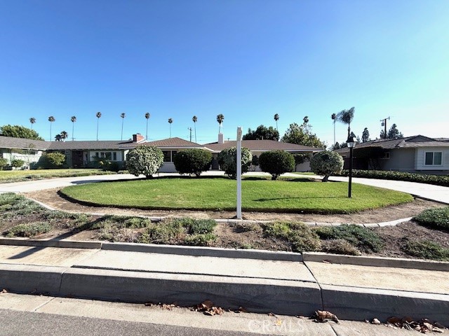 Location, location, location. Welcome to this spacious and gorgeous 3-bedroom, 2.5-bath home, nestled on a picturesque tree-lined street in the heart of Glendora. Combining timeless charm with spacious living, this single-story residence sits on a generous 10,003 sq ft lot and offers incredible potential along with a warm, inviting atmosphere from the moment you arrive. A circular driveway and lush, manicured landscaping set the tone, while classic brick detailing around the chimney adds to the home’s curb appeal. Inside, you are greeted by a light-filled living room with a dual-sided fireplace, creating a cozy yet elegant focal point. Property has been total remodeled inside out with new bathrooms, new kitchen, new floorings, new paint inside and out, new lighting, new kitchen appliances and so on. The space flows effortlessly into the dining area—perfect for entertaining or enjoying quiet family dinners. The adjacent family room exudes character with rich wood paneling, exposed beam ceilings, and a floor-to-ceiling stone fireplace. Sliding doors lead to a covered patio, ideal for morning coffee or evening gatherings, all overlooking the expansive backyard with a lush lawn and mature trees that offer privacy and shade. The kitchen has a large front-facing window that fills the space with natural light. A dedicated laundry room adds convenience to everyday living. Each of the three bedrooms is generously sized and one is a master suite, while the two and half bathrooms are functional and brand new. Located just minutes from schools, local parks, and the vibrant Glendora Village, this is a rare opportunity to own a home on a big lot in a highly sought-after neighborhood. Please come by and check it out this wonderful property.