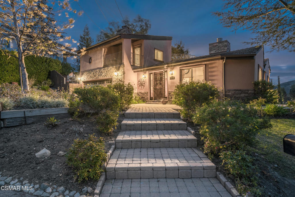Escape to a private retreat tucked away on nearly an acre of enchanting, view-filled landscape. This custom home seamlessly blends indoor and outdoor living, offering panoramic, long-range vistas of the Santa Monica Mountains from almost every window and deck on the property. Whether you're seeking ultimate privacy, multi-generational living, or flexible spaces for all your passions, this residence delivers. A versatile, thoughtfully designed floor plan features three distinct living spaces--perfect for families, guests, or creating dedicated work and creative zones. The main level hosts a tranquil primary suite, a serene hideaway with its own secluded balcony--perfect for morning coffee or leisurely afternoons overlooking the mountains. Upstairs, a second luxurious primary suite awaits, offering a spacious bathroom, cozy fireplace, and private rooftop deck where you can unwind under a canopy of stars. On the lower floor, find an oversized studio--with its own entrance, kitchen, full bathroom, fireplace, and sweeping mountain views--makes an ideal guest retreat, creative studio, or entertainment lounge. The main floor also has a regular bedroom & hall bath in addition to the aforementioned primary suite. At the center of the home is a chef's kitchen, featuring stainless steel appliances, a breakfast bar, and a warm fireplace, fostering memorable gatherings. Step outside to a scenic terrace, tailor-made for al fresco dining, sunset cocktails, and evening conversations under golden skies. Horse and animal lovers will delight in the dedicated lower property--accessed by a second driveway--and housing two high-quality horse stalls and a sizable turnout, complete with hay and tack storage. Sunny and shaded areas make this haven ideal for nurturing horses, minis, goats, or other animals--or easily convert the space for a home gym, workshop, or expansive garden. Additional highlights include four full bathrooms, two kitchens, four fireplaces, five decks, and an inviting rustic brick patio. Two driveways provide ample parking, including an RV space. One of the driveways is gated and leads down to the horse area. Located in the sought-after equestrian community of Old Agoura, you'll enjoy peaceful country living just minutes from city amenities, top-rated Las Virgenes schools, private academies, and a stunning 4,000-acre National Park with world-class hiking, riding, and cycling trails. Whether you're hosting lively gatherings on the patio, relaxing by a crackling fire, or simply savoring the serenity and privacy of your own grounds, this rare property invites you--and your guests--to linger, unwind, and truly feel at home.