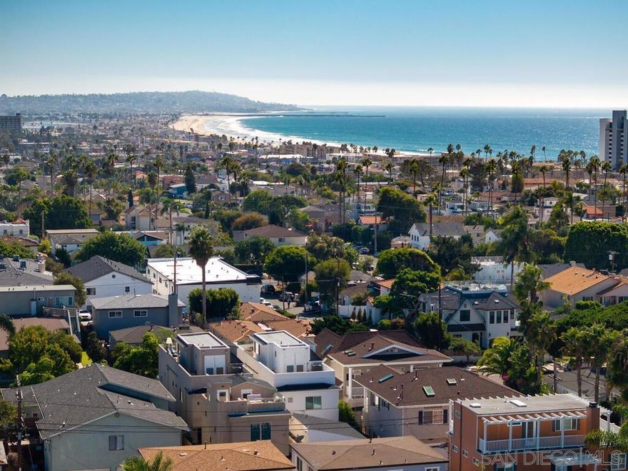 Pacific Beach at its best! Built in 2018, this modern coastal home has been immaculately maintained, boasts high end stainless appliances and designer finishes throughout, and comes with an open and intelligent floor plan perfect for formal entertaining or just casual day to day beach living. The recent addition of a detached, fully permitted 1BR, 602sqft ADU complete with separate entrance and its own private roof deck, only adds to the flexibility of this offering. Three blocks to the beach, walk to restaurants, shops, and both elementary and middle schools. Enjoy bay, ocean and coastline views south to the Coronados. See supplement for more property details...  The main house is 2331sqft, with 3BR/3.5BA, an optional den/family room/office on main floor and an additional suite on the 3rd level with full bath, wet bar area, wine fridge, and expansive deck with fireplace and views of the coastline to the south.  Finishes include shaker cabinets in the kitchen, quartz counters, Jenn-Air extra wide range with hood and pot-filler and custom back splash.  La Cantina doors open from the family room to the front patio, while large wall to wall sliders open the living area to the back yard patio providing a seamless flow of indoor/outdoor living.  The master suite has its own private lanai, fireplace, walk in closet and bath with custom tile work and fixtures, rainfall shower and separate tub.  There's a 2-car detached garage off the alley with ample height for overhead storage.  Above the garage sits the newly constructed ADU, providing an additional 602sqft (as per plans) of living space with the same quality of finishes as the main house.  The ADU has its own private entry, separate bedroom from living area, laundry closet and a good sized private roof deck with views.