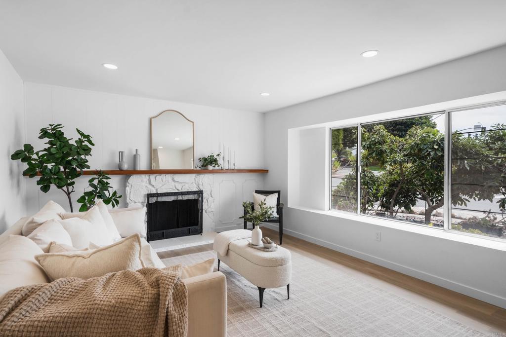 This beautifully refreshed home offers a perfect blend of modern style, natural light, and warm livability. A thoughtful layout with multiple gathering spaces and inviting interiors provide seamless indoor-outdoor flow. The bright & spacious living room is framed by an oversized picture window and centered around a stone fireplace. Freshly painted interiors, new flooring, and modern fixtures create a clean, elevated aesthetic. A flexible floorplan features both a formal living room and a cozy family room with wood-beamed ceilings, offering plenty of space for entertaining, relaxing, or working from home. New air conditioning ensures a comfortable environment. Sliding glass doors open to a private backyard patio ideal for hosting friends, al fresco dining, or enjoying San Diego’s year-round sunshine. Minutes from freeway access, this home combines suburban tranquility with city convenience.