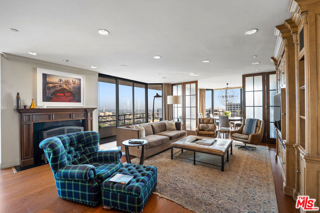 Welcome to one of the most coveted addresses on the Wilshire Corridor, Wilshire House, the only "A" building with wrap-around balconies. This completely remodeled southwest-facing residence showcases spectacular city vistas, ocean views, and Catalina Island on a clear day, all framed by floor-to-ceiling glass and a balcony that spans the length of the condo. Step into a grand marble entry that flows into a sophisticated living space with hardwood floors and abundant natural light, ideal for entertaining. The dining room opens to the stunning views and features a one-of-a-kind custom bar designed for unforgettable gatherings. The kitchen offers new appliances and elegant finishes. The luxurious primary suite boasts two walk-in closets and a marble bath. The second bedroom with its own bath works beautifully as a guest room, den, or home office. Special features include a built-in wine cellar and custom leather floors in the dining room and primary bedroom. Wilshire House Amenities: 24-hour valet & security, In-house engineers for on-demand repairs, lit tennis court, Saline swimming pool, & spa, fire pit & outdoor entertaining area, State-of-the-art fitness center, Recreation/banquet room, library, elegant lobby with a tranquil waterfall feature. No open houses permitted; private tours available by appointment.