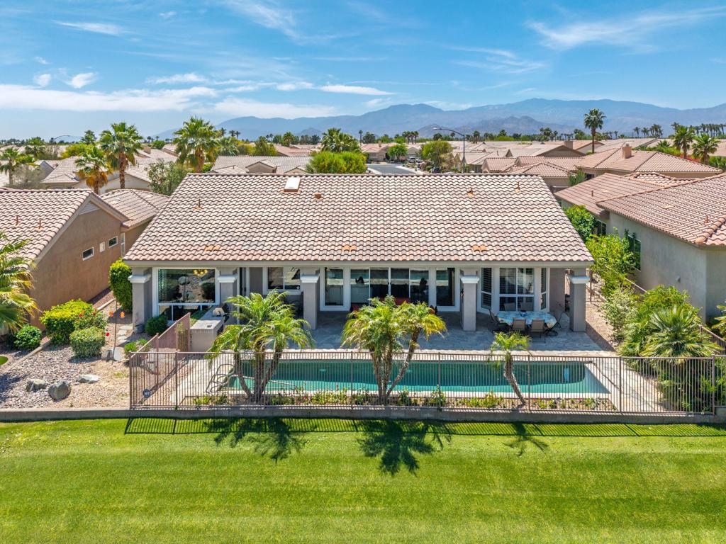 Sun City Palm Desert - Monaco. Located just around the corner from the Lakeview Clubhouse and sitting elevated over a lush greenbelt that includes the 18-hole putting course, practice greens and lake, this is a special opportunity. The spacious rear yard features a pebbletec lap pool surrounded by a flagstone patio from which panoramic greenbelt and mountain views can be enjoyed. An updated paint scheme, decorative concrete driveway, gated front courtyard with flagstone patio and double door entry provides curb appeal. Inside, the feeling is big and bright. 12ft ceilings are the in the greatroom. 10ft ceilings are elsewhere. The interior is freshly painted. Diagonally laid tile flooring is in all but the bedroom. The greatroom features a double slider to the rear patio and crown molding. Crown molding is also in the family room. Shutters on all but the greatroom and familyroom view windows. Off the family room is spacious office/utility room. The kitchen features granite counters, a chef's island with breakfast bar, skylight, large pantry and cabinets with pull-out shelves. Maple cabinets are in the kitchen and bathrooms. The primary suite has a bay window looking out over the pool and greenbelt. It has a large walk-in closet with built-in storage. The primary suite bathroom has a vanity with upgraded dual sinks, fixtures and granite counter along with an oversized tub and stall shower with glass enclosure. The guest suite bathroom also has a vanity with granite counter, upgraded sink and fixtures along with a stall shower. There is also a second guest bedroom. The extended 2+ golf cart garage has an epoxy floor, built-in storage and a utility sink. The home is equipped with dual AC with electronic air filtration.