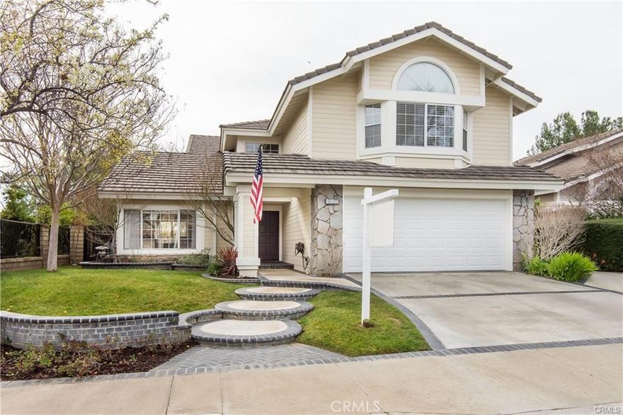 Welcome to this beautiful 5 bed, 3 bath home in Santa Clarita with approx. 2,350 sq. ft. featuring hardwood floors, open floor plan. The kitchen offers granite counters, stainless appliances, upgraded island, and glass pantry door. Spacious family room with fireplace and built-ins. Downstairs includes a  full bath, and indoor laundry with direct garage access. Upstairs, the large primary suite boasts high ceilings, natural light, and stunning views, plus a remodeled bath with tub, shower, and new finishes. Additional bedrooms are generously sized with a versatile bonus room. Backyard is ideal for entertaining with patio, play area, and unobstructed views.