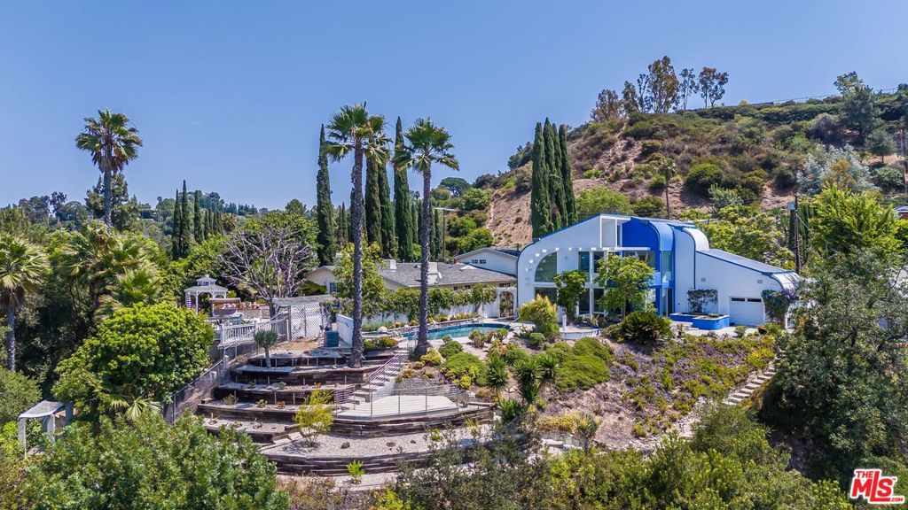 Step into The House of Light a soul-stirring sanctuary perched in the prestigious hills of Bel Air. Radiating tranquility and sophistication, this rare retreat channels the ethereal beauty of Santorini with the elevated elegance of California luxury.Bathed in golden natural light and framed by breathtaking canyon vistas, every inch of this residence is a masterclass in serenity and intention. With 2 bedrooms, 3 baths, and approx. 2,429 sq ft of curated living space, the home flows effortlessly across expansive interiors and peaceful outdoor terraces, creating an atmosphere that nourishes both body and soul.Set on an ultra-private 15,893 sq ft lot, this gem offers an intuitive layout perfect for intimate living or inspired entertaining. Open-concept living areas, refined finishes, and endless windows blur the line between indoors and nature. From sun-drenched mornings to twilight reflections, this home captures magic at every hour.Moments from Bel Air's most exclusive offerings, yet worlds away from the noise this is where elegance meets elevation, where dreams are grounded in stone and light.Whether you're seeking a serene escape, an artist's muse, or the next chapter of your legendary life The House of Light is your call to rise. A once-in-a-lifetime offering. Shown only to those who are ready to claim it Call directly.