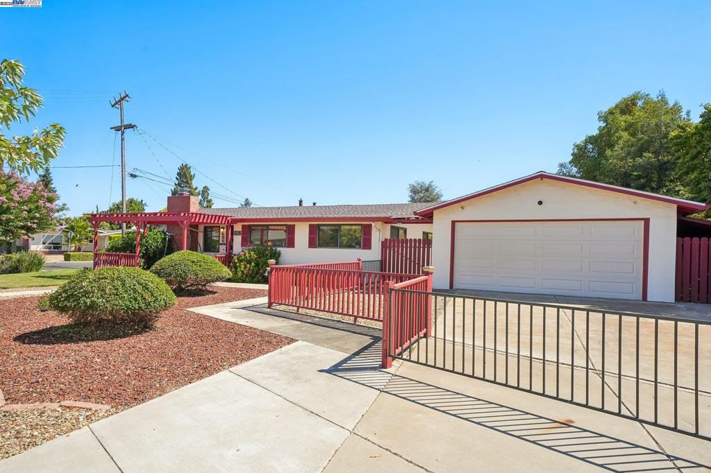 Fantastic corner lot full of charm, space and possibilities! A large gated deep driveway with detached garage plus a second driveway - together can provide parking for multiple vehicles! The welcoming front door faces west, while the family room offers its own north-facing entry and driveway. Step inside to discover hardwood floors, a striking fireplace mantel, nicely painted interior, granite kitchen counters, plentiful cabinetry, and a hall bathroom filled with natural light from the skylight. You’ll also enjoy the convenience of indoor laundry, dual-pane windows, and a soaring vaulted ceiling. Outside, relax on the front porch decking, entertain in the spacious backyard with additional decking, or unwind in the hot tub. Both sides of the home feature gated access with covered area, perfect for extra storage. New Roof 2025 and HVAC 2022. This home has so much to offer and has been lovingly maintained—and it truly shows!
