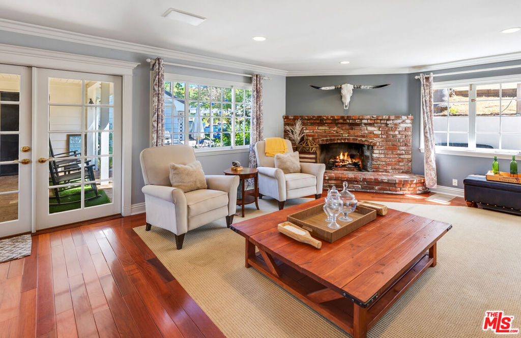 Welcome to this beautiful one-story ranch style home on a lot that has over an acre, nestled in the breathtaking beauty of Bell Canyon. This extraordinary residence is your opportunity to own a piece of paradise, surrounded by picturesque views that make every day feel like a retreat.Step inside to discover the elegance of rosewood hardwood floors that grace the formal dining room and kitchen. The state-of-the-art kitchen is a chef's dream, featuring custom cabinets adorned with bead board wainscoting, exquisite granite counters highlighted by a travertine backsplash, and top-of-the-line Viking gas range complete with a pot filler and a spacious center island. The charming breakfast area boasts a delightful window seat and diamond-patterned windows, perfect for enjoying your morning coffee.The open floor plan flows seamlessly into the family room, where a used brick fireplace and built-in cabinets create a warm and inviting atmosphere, enhanced by the natural light streaming through the French windows. The step-down living room captivates with an enormous stone fireplace, providing a cozy focal point for gatherings.Retreat to the spacious master suite, featuring two closets and an updated bathroom that exudes luxury with travertine counters, double sinks, and a spa tub designed for relaxation. The hall bathroom dazzles with hand-painted tiles and double sinks, combining functionality with artistic flair.Convenience is key with a large laundry room that includes an adjacent sauna and shower, perfect for unwinding after a long day. The meticulous attention to detail throughout the home includes crown molding, bead board, wainscoting, and custom woodwork that showcases elegance at every turn.French doors lead to a covered brick patio, ideal for entertaining or simply enjoying the serene surroundings. The covered grape arbor opens to a generous grassy side yard, adorned with fruit trees and stunning views, creating a tranquil outdoor oasis.Located in the prestigious gated community of Bell Canyon within the Las Virgenes School District, residents enjoy a wealth of amenities including a fitness center, tennis courts, parks, an equestrian center, and scenic trails. This home is not just a residence; it's a lifestyle filled with charm and sophistication. Don't miss your chance to experience all that this remarkable property has to offer!