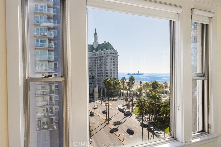 Gorgeous panoramic views from the top floor of this corner unit overlooking the ocean and beautiful downtown Long Beach. These views are breathtaking at any time of day or night and are a must-see in person. Located in the well-known Artaban building, this large one-bedroom unit has a second room set up as an office space, ideal for work from home or having guests enjoy your home with the fantastic views. You can enjoy ocean views from the living room and bedroom. As you enter the building, you are greeted by the lobby, which takes you back in time to appreciate the history of this building. Enjoy the top roof level solarium with amazing views and a setup your friends will never want to leave. The building has a community laundry onsite, an exterior garden area with outdoor seating, and a bike storage room. The HOA includes water, electricity, gas, and building maintenance. There are local options for parking, and the next best thing besides the views is that it is located downtown, close to Shoreline Village, The Queen Mary, The Aquarium, various restaurants, and easy access to the freeways. This home lets you put love into an amazing space with breathtaking views.