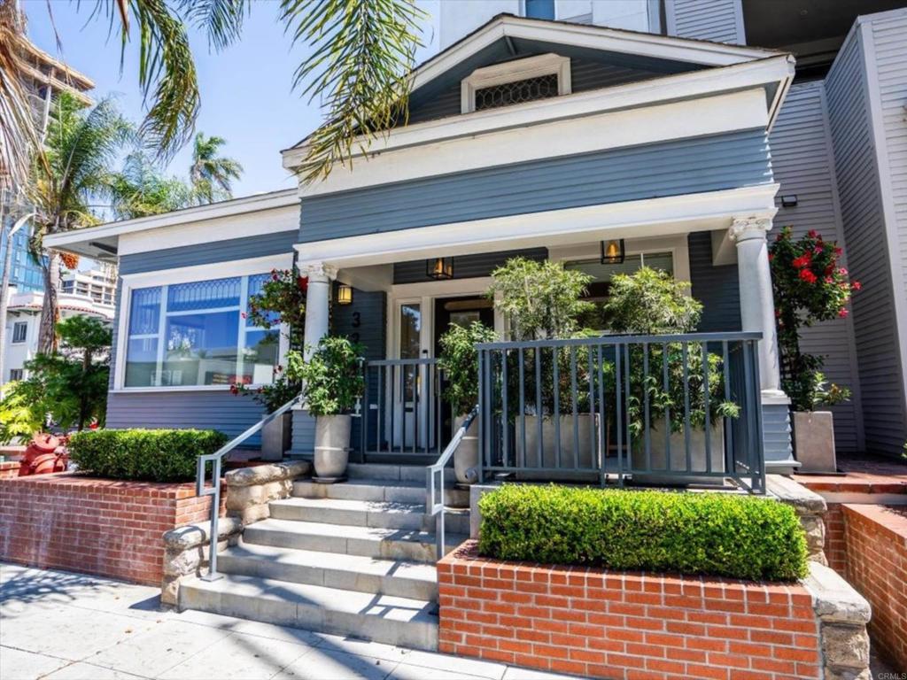Steps from Balboa Park, this pristine home blends timeless early 20th Century Craftsman charm with modern luxury. Historic character shines through the facade, with the original leaded glass windows, bronze door accents, and grand columns—all meticulously preserved during the 2008 construction. This home lives like a single-family residence, featuring a private gated entrance off 5th Avenue and three dedicated garage parking spaces. The historic exterior transitions seamlessly to a well apportioned modern interior, complete with premium finishes and appliances. Inside, 10-foot ceilings and expansive windows fill the open-concept living space with natural light. The layout includes two spacious primary suites and a third room perfect as an office or guest bedroom. Designer finishes include wide-plank hardwood floors, recessed lighting, quartz countertops, and custom paint throughout. The gourmet kitchen boasts soft-close cabinetry and top-of-the-line Bosch appliances, including a French door refrigerator, 5-burner gas range, and microwave drawer. All three bathrooms are beautifully renovated with custom tile, frameless glass showers with rain heads and body wands, and a luxurious freestanding tub. Enjoy smart living with integrated features such as motorized blinds, a Ring Doorbell, Lutron lighting, a Nest thermostat, and Brilliant Smart Home control—all voice-activated or app-controlled. Two private patios and access to a sprawling shared courtyard with fire pits, BBQs, and dining areas provide ideal spaces for indoor-outdoor living. Additional highlights include a private rear entrance, dedicated laundry room with quartz counters and Samsung appliances, four walk-in closets, a soundproof ceiling, and upgraded double-pane windows—including historically preserved ones. Bonus amenities include a private basement storage area, secure bike room, and no shared walls for maximum privacy. HOA covers high-speed internet, water, trash, sewer, landscaping, exterior maintenance, and even housekeeping of common areas. Perfectly positioned in Bankers Hill, just a half block from the west entrance of Balboa Park, this home offers unbeatable walkability to Hillcrest, Little Italy, and Downtown. Enjoy front-row views of the city’s biggest events right from your doorstep. With coastal breezes, walkable culture, and endless dining just outside your door, this home is truly one-of-a-kind.