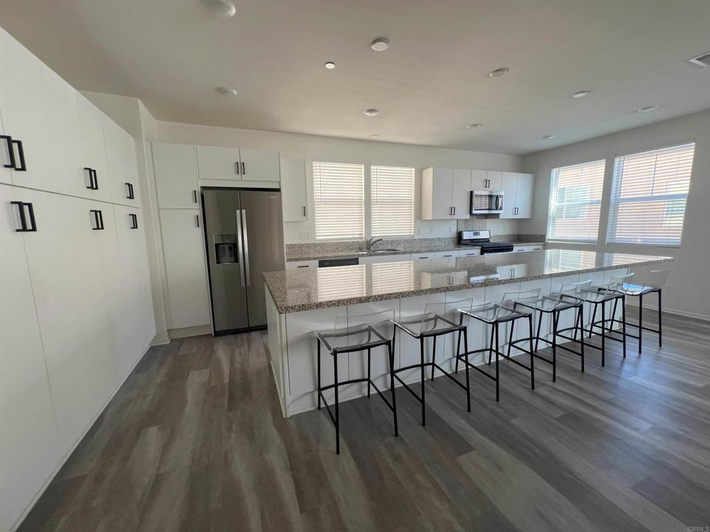 Discover coastal living at its finest in this bright and elegantly upgraded 3-story corner unit in Plays de Sol, Ocean View Hills. With 3 spacious bedrooms and 4 modern bathrooms (2 full, 2 half), this 2,047 square foot home offers the perfect blend of style and convenience. The professionally finished design features restorative, cheerful, earthy tones, textures, and furnishings. Enjoy the expansive high ceilings, a huge kitchen with an oversized island, energy-efficient appliances, and ample storage space. No carpet- premium vinyl flooring throughout. The welcoming balcony and open layout are perfect for entertaining and bring the lovely outdoors IN! The oversized 2-car garage and tankless water heater add to the efficiency and functionality of this well-maintained home. The gated community provides extra vigilance with 24-hour security, and the HOA includes access to a shared fitness room, pools, a jacuzzi, and a clubhouse for special events. Ideally located near downtown San Diego, with easy access to the 905, 805, and 5 freeways, South San Diego beaches, and the Mexican border, this home offers the best of both worlds— modern living and prime location. Pet friendly!
