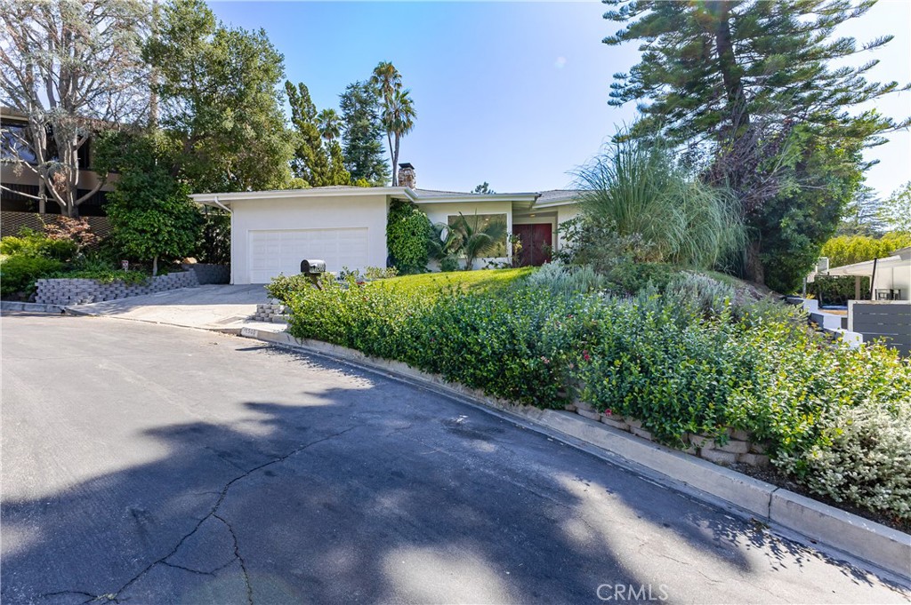 Located on a quiet cul-de-sac in the highly sought after Donas neighborhood, this tastefully updated single-story home offers the perfect blend of comfort, style, and convenience. Designed with an open concept layout filled with natural light, the home features a formal entry, a spacious living room with a fireplace, and a family/dining area that flows seamlessly into a modern kitchen with Carrara marble countertops and stainless steel appliances. Recent upgrades include new hardwood floors, multiple skylights, a freshly painted interior, and a remodeled hallway bathroom. The primary suite features a walk-in closet and en-suite bath with a spa tub and separate shower. Step outside to a private backyard oasis with a sparkling pool with waterfall feature, a spa, two grassy areas, and a large covered patio, perfect for year-round entertaining. Conveniently located with easy access to the Westside and the Fryman Canyon trailhead, this home offers relaxed California living in a prime Studio City location.