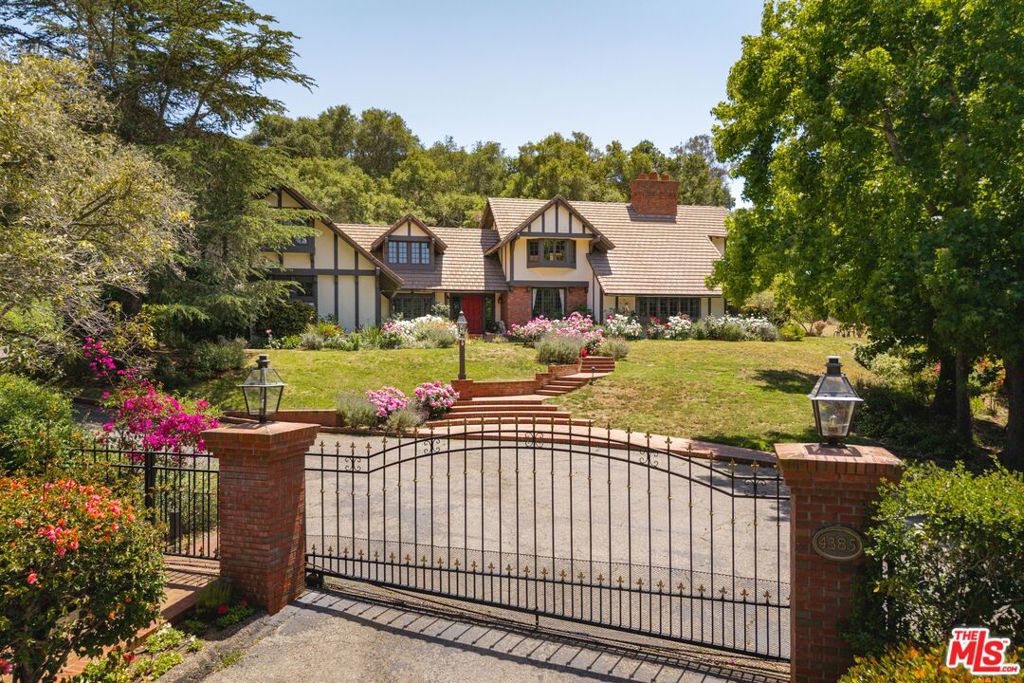 Escape to your own private oasis in this enchanting and spacious Hope Ranch home! Nestled on +/- 1.6 gated acres with mature trees and landscaping, the 5 bed/4.5 bath residence offers ample space inside and out for relaxing or entertaining. Additional amenities include a tennis court and guest quarters with a separate entrance.Inside, character and charm abound at every turn. The main living areas feature open beam and vaulted ceilings, bay windows, custom woodwork, and cozy fireplaces. Multiple French doors lead to expansive patio areas, welcoming natural light and enhancing enjoyment of the home's serene setting. The gourmet kitchen provides abundant counter space and storage, ready to support any culinary enthusiast. Soaring vaulted ceilings in the living room create an open and airy ambiance, while a game room on the main level offers exciting possibilities, flexibility, and easy access to the outside.Upstairs, a roomy primary bedroom offers a comfortable getaway -- complete with a fireplace, en suite bathroom, and an enticing built-in reading nook. Three additional bedrooms provide pleasant accommodations for family, guests, or the ideal space for an office. A 1 bed/1 bath guest suite above the 2-car attached garage has its own separate entrance, ensuring convenience and privacy.Outside, the park-like grounds host numerous opportunities to relax and be refreshed. Meandering pathways amble along various garden areas & shady oaks, while the tennis court beckons daily recreation. A gated entrance provides additional security. With sophisticated yet comfortable style, this elegant property offers an exceptional retreat in Hope Ranch.