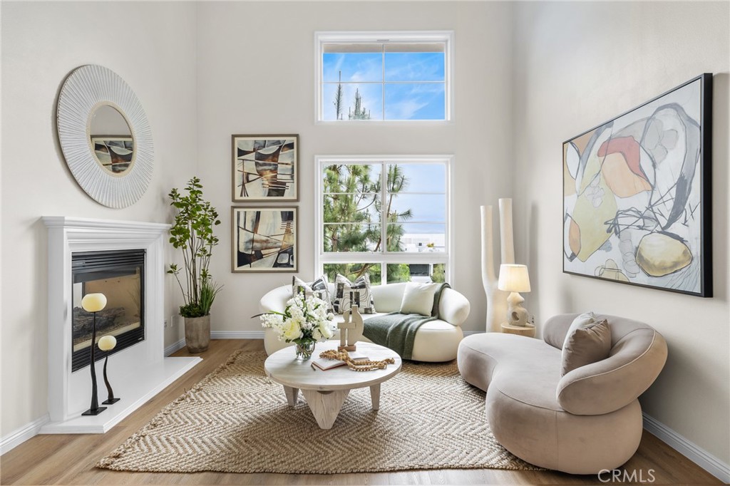 Welcome to the exquisite top-floor corner unit boasts three bedrooms plus a versatile loft that can serve as a fourth bedroom, offering stunning sunset views. Located in a gated complex on the tranquil cul-de-sac of Playa Vista, this recently updated home exudes elegance and privacy. Upon entry, you are welcomed by the grand living spaces featuring cathedral ceilings, and expansive picture windows that flood the rooms with natural light and showcase serene northwest-facing views. The second floor presents a formal living room and a cozy family room connected by a striking double-sided fireplace. The open kitchen, adjacent to a sunlit dining area, is generously sized and equipped with granite countertops, stainless steel appliances, a spacious center island, ample cabinet space, and a beautiful wraparound balcony that bathes the space in sunlight. Ascend the open stairway to the third floor, where a bright and airy loft offers flexibility as a home office, gym, or additional bedroom. Descending to the first floor, you will find three bedrooms and two bathrooms, including the luxurious primary en suite with a separate shower, soaking tub, dual vanities, a private water closet, and a sizable walk-in closet. The guest rooms share a Jack-and-Jill bathroom for added convenience. This home also includes side-by-side parking in a prime location near the elevator and a private storage unit. Embrace the coveted Playa Vista lifestyle with access to parks, walking paths, premier shopping and dining, a weekly farmers market, The Resort pool and activity club, and close proximity to the Ballona Wetlands, Venice Beach, and Playa del Rey. Make this charming residence your own with the unmatched experience of living in Playa Vista.