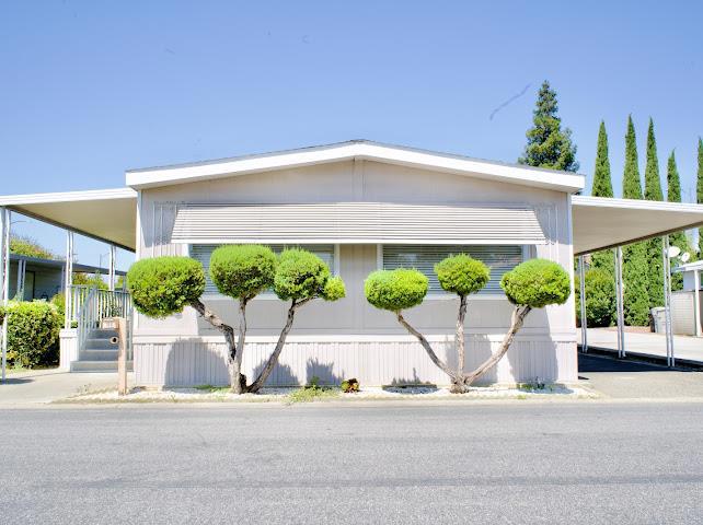 Welcome to this beautifully remodeled double-wide home in an all-age park! With 1,650 sqft, featuring 2 bedrooms plus a versatile office (could be the 3rd bedroom), this spacious residence offers both a separate living and family room. The home boasts two full bathrooms, including a luxurious master bath with a jacuzzi tub. Upgrades include recessed lighting, crown molding, copper plumbing, central AC/heating, and a mix of laminate and marble flooring. The custom kitchen and bath cabinetry are topped with elegant granite countertops and paired with stainless steel appliances. Additional highlights: new interior paint and a new water heater tank. A must-see turnkey property with modern touches throughout! Enjoy a cozy front patio and a covered balcony perfect for relaxing or hosting guests. Spacious backyard perfect for gardening!