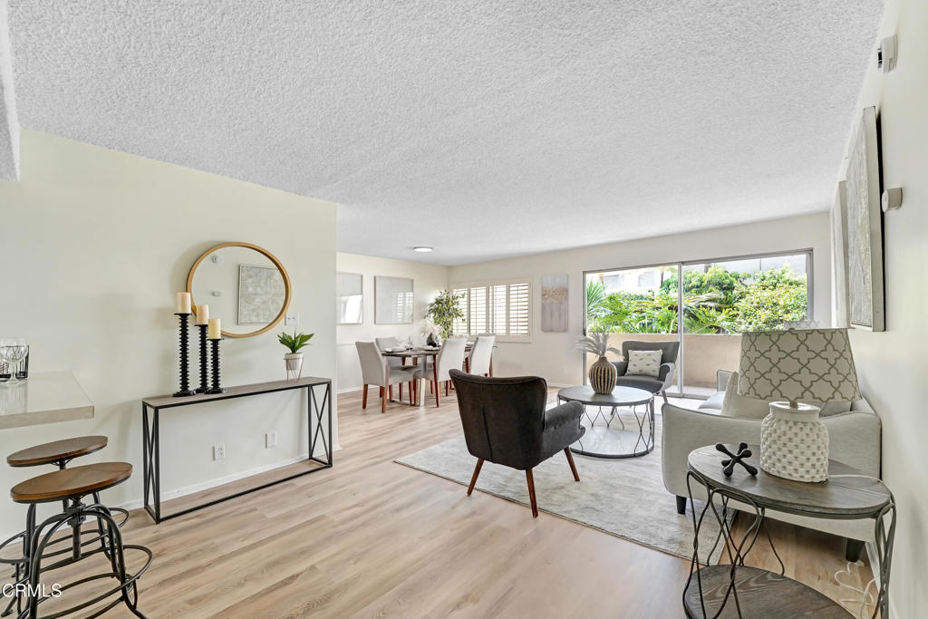 Welcome to your serene Glendale retreat! This beautifully maintained 1-bedroom, 2-bathroom condo blends comfort, functionality, and resort-style amenities. Step inside to discover a bright and inviting interior with an open-concept living and dining area, bathed in natural light from expansive sliding glass doors that lead to a private patio surrounded by lush greenery. The charming galley kitchen features crisp white cabinetry, updated hardware, and sleek countertops, perfect for both everyday living and entertaining.The spacious bedroom offers a peaceful sanctuary with an en-suite bath, generous closet space, and elegant finishes. A second full bathroom adds convenience for guests or working from home. Stylish flooring flows throughout, complemented by tasteful decor and modern lighting.Outside, enjoy the sparkling community pool surrounded by tropical landscaping, comfortable lounge seating, and shaded dining areas--ideal for soaking up the California sun. This condo is located in a well-kept, secure building just minutes from the Americana at Brand, Glendale Galleria, dining, and freeway access.