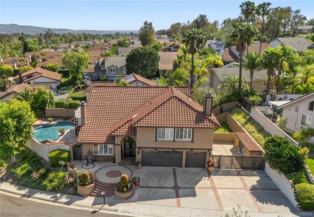 Experience upscale living in this beautifully 6 bedroom, 3 bathroom, 3,221 SQ FT pool home in the highly desirable EAST LAKE community of Yorba Linda. The hole is entertainer's dream with breathtaking panoramic view of the community and east Lake from the expansive wrap around balcony off the luxurious master suite.
Step inside to find a soaring 2 story ceiling and tile flooring throughout the main level. the home features plantation shutters, recess lights, ceiling fans
and fireplace in living room/family room. The spacious living room and dinning room open to the backyard and pool.
The family room flow into a beautifully appointed kitchen with crown molding, granite countertop, stainless steel appliance including double oven, 5 burner range, build-in refrigerator, and a bay-window with view of backyard.
Down stair offers a full bedroom and bathroom, along with a laundry room. Up stair, the master bed room boasts double door entry, vaulted ceiling and ceiling fan, and a large bathroom with dual vanities, soaking tub, glass enclosed shower and a window over looking the yard.
The home includes a spacious 3 car garage with side yard suitable for RV parking.