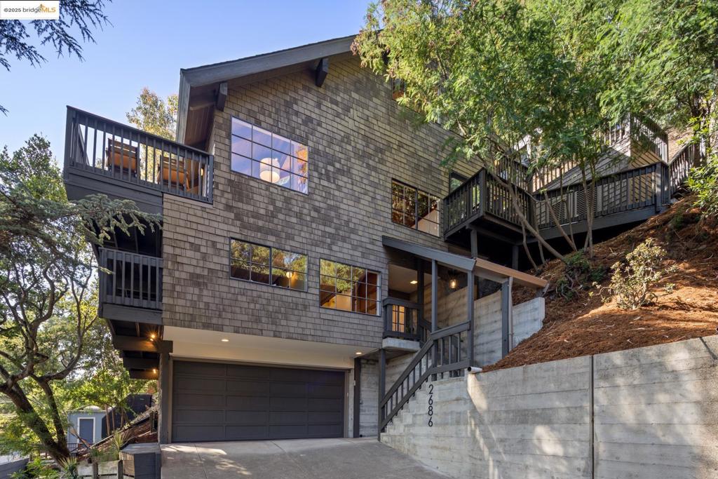 Enjoy privacy and serenity in this stunning contemporary treehouse in the lower North Berkeley Hills! The unique design features decks at every level, multiple skylights, and soaring ceilings, and is beautifully crafted to embrace its natural surroundings. It has been recently updated and refreshed, bringing a modern sensibility to the warmth of natural wood, tile, and stone. The entry-level offers two spacious bedrooms, a renovated split bathroom, and a shared deck with views of the surrounding greenery. Ascend to the main level where the dramatic living room opens seamlessly to a full-width front deck—perfect for entertaining or unwinding amid the treetops. The thoughtfully designed kitchen is at the heart of the home, featuring granite countertops, a premium Wolf cooktop, and brand-new (2025) stainless steel appliances. The top floor is dedicated to an expansive primary suite, complete with a private deck retreat and an adjacent office with a picture-perfect window framing views of the San Francisco Bay. Located in a peaceful neighborhood known for its network of hidden pathways, proximity to local parks, and easy access to North Berkeley’s acclaimed restaurants, UC Berkeley, downtown, and BART. A one-of-a-kind sanctuary where modern living meets natural beauty.