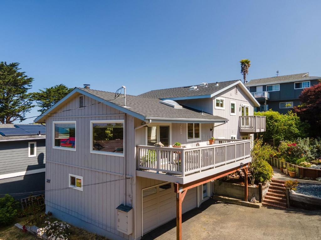 Tucked at the top of 14th Street, this Montara gem offers privacy, ocean views, and flexible living. The upper level features 3 bedrooms and 2 baths with designer touches throughout - wood floors, curated finishes, and great natural light. The open living area flows to a deck, offering your own serene spot for morning coffee or sunset unwinding. Two of the bedrooms also enjoy ocean views, while the primary suite opens to its own private deck. Downstairs offers 1 bedroom, 1 bathroom and a family room with a separate entrance. Providing ideal space for guests and extended family. Out front, a lush and colorful garden adds charm and curb appeal, while the peaceful setting feels like a true retreat. Just minutes to trails, beaches, and Montaras local spots, this home is anything but cookie cuttercoastal living at its finest.