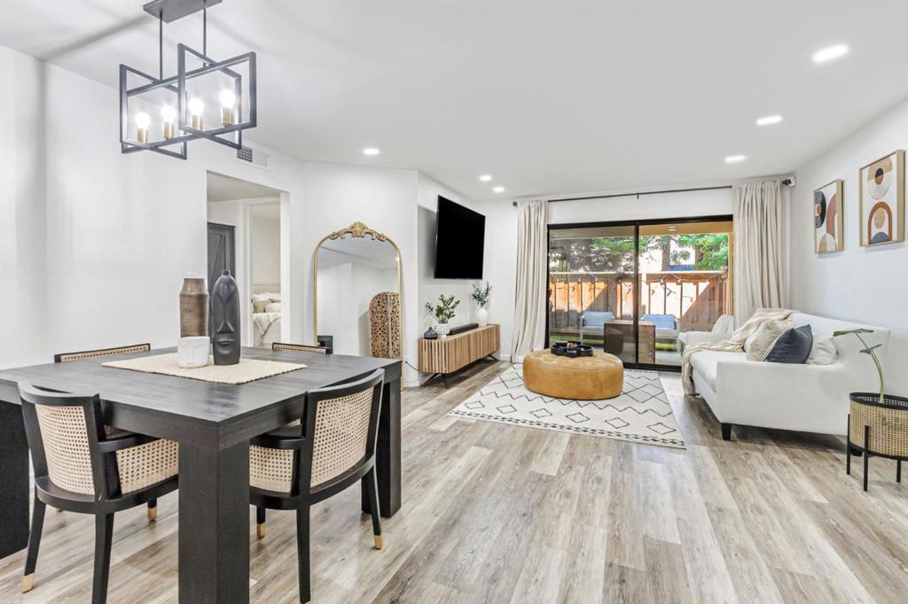 This charming, open-concept 2-bedroom, 1-bathroom ground-floor end unit is located in a quiet, family-friendly neighborhood & offers plenty of living space & a surprising amount of storage. The renovated C-shaped kitchen (2024) features updated cabinets, new backsplash, stainless steel appliances, under-cabinet lighting, quartz countertops & open shelving. The dining area flows seamlessly into the living room, which offers dimmable recessed lighting & opens to a large, partly covered private patio with artificial grass & two storage closets. The larger bedroom sits at the back with a peaceful view of the patio & a full wall of closets. The second bedroom is up front with a closet organizer, making it ideal for guests or a home office. The renovated bathroom (2024) includes a floating vanity, updated tile & a tub with stylish fixtures. Additional highlights include in-unit laundry & an entryway closet. This home enjoys added privacy with no rear-facing neighbors & an assigned carport space conveniently close to the unit. The lush community offers a pool, spa, clubhouse, mature trees, greenery & guest parking. Walk to Target, Starbucks, 24 Hour Fitness, restaurants & shopping. Quick access to Hwy 85, 880/17 & Almaden Expressway. Assigned to highly rated Branham High School.