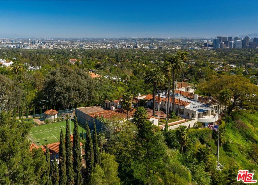 Off lower Benedict Canyon and behind a long private drive lies this 2.5 acre view promontory compound. A home to multiple, famed Hollywood royalty, a large motor court and courtyard welcomes you to spectacular views from downtown Los Angeles to the ocean and the Santa Monica mountains. The main house contains two suites, multiple entertaining areas and seven fireplaces. There are two separate, detached guest houses as well as a screening room, a pool house with two baths and a lighted tennis court, all in a dramatic, private unparalleled setting.