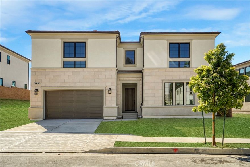 Lavishly Luxe and Exceptionally Styled Home with Intoxicating Views! Idyllically nestled in the highly coveted gated community of Verona Estates, this 5BR/4.5BA, 4,709sqft is the ultimate entertainer's dream home. The home features a spectacular backyard with city views that is perfect for hosting. The Bari floor plan captivates with its grand entrance, leading into a stunning two-story great room and an expansive indoor/outdoor living area. The thoughtfully designed kitchen serves as the heart of the home, featuring Wolf and Sub Zero Appliances, a spacious casual dining area, an oversized island with breakfast bar, ample counter and cabinet space, and a generous walk-in pantry.The primary suite is a true retreat, boasting a large walk-in closet and a luxurious bath equipped with dual vanities, a soaking tub, a spacious shower with a seat, and a private water closet. A sizable loft overlooks the great room, providing additional living space. The secondary bedrooms are well-appointed, with one featuring an en-suite bath, while the other two share a hall bath with a separate dual-sink vanity area, all equipped with walk-in closets for added convenience. This layout perfectly balances style and functionality, making the Bari a remarkable choice for modern living. Other features: Multi-Gen suite with private entrance, SOLAR, 3 car garage and Top Rated Schools: Sierra Canyon, PRCS. Walking distance to shops, restaurants, movie theater, parks and grocery stores.. Schedule your viewing today and experience the perfect blend of luxury and functionality. Available for showings after Dec. 15th