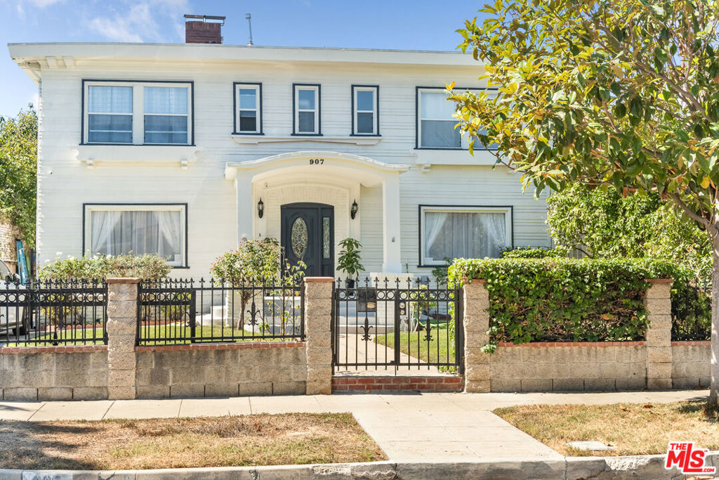 A location of this caliber is truly irreplaceable. Ideally situated on one of the most coveted, tree-lined streets in Wilshire Park HPOZ, 907 Westchester Place sits among a collection of architecturally significant homes that define this historic enclave. This Craftsman-influenced American Foursquare, enriched with Colonial Revival, faces east, welcoming the morning sun and bathing the interiors in abundant natural light throughout the day. The property has been taken down to the studs and thoughtfully rebuilt with a careful balance of preservation and modern refinement. The residence offers over 3,400 square feet of living space across 4 bedrooms and 4 bathrooms, featuring soaring ceilings, custom millwork, and interiors showered with natural light. The chef's kitchen pairs timeless white shaker cabinetry with marble countertops, creating a space that is both elegant and functional. Beyond, the expansive backyard unfolds into a private retreat with a basketball court, and generous space for a future pool or ADU. The detached garage is convenient to have and is ready for conversion into additional living space ideal for guests, a studio, or income-producing potential. Moments from Hancock Park, Koreatown, and the city's finest cultural destinations, this home offers the rare opportunity to own a masterfully restored piece of Los Angeles historyone that gracefully balances architectural heritage, modern living, and enduring value.